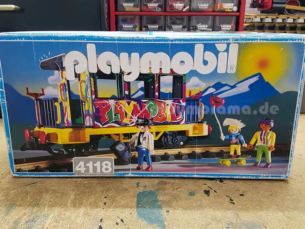 Karton Playmobil "Graffiti-Wagen" 4118 aus dem Jahr 1996 steht auf einer Werkbank.